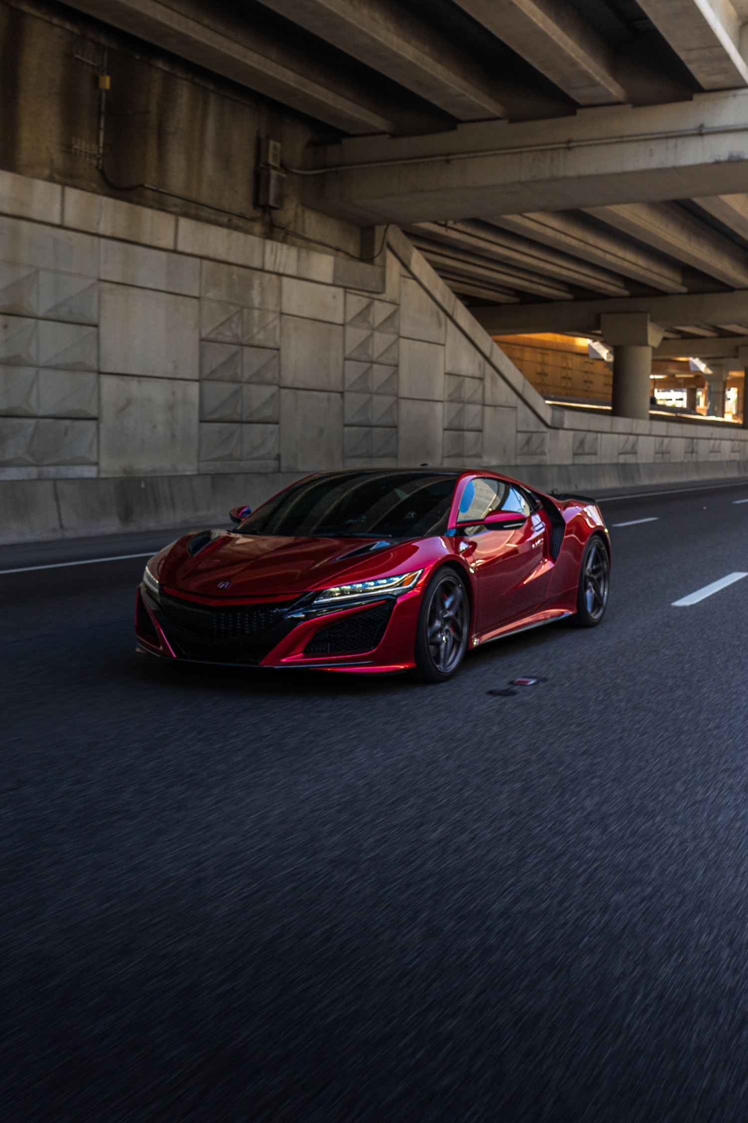 Front view of the red Acura NSX on the road